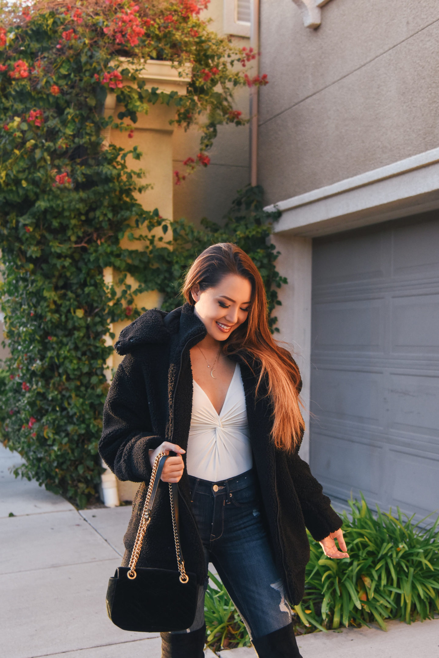 brunette wearing teddy jacket over the knee boots winter out