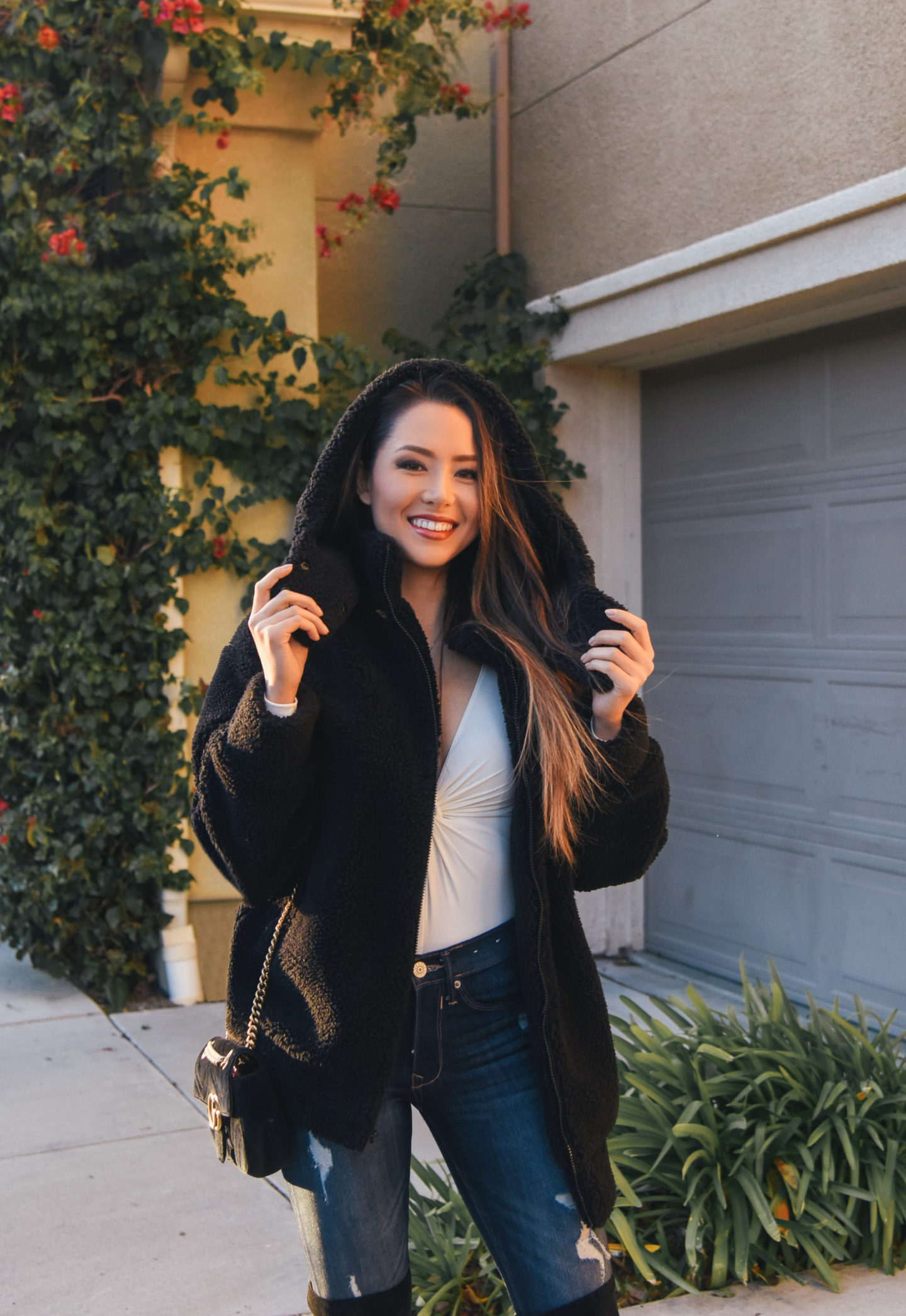 brunette wearing teddy jacket over the knee boots winter out
