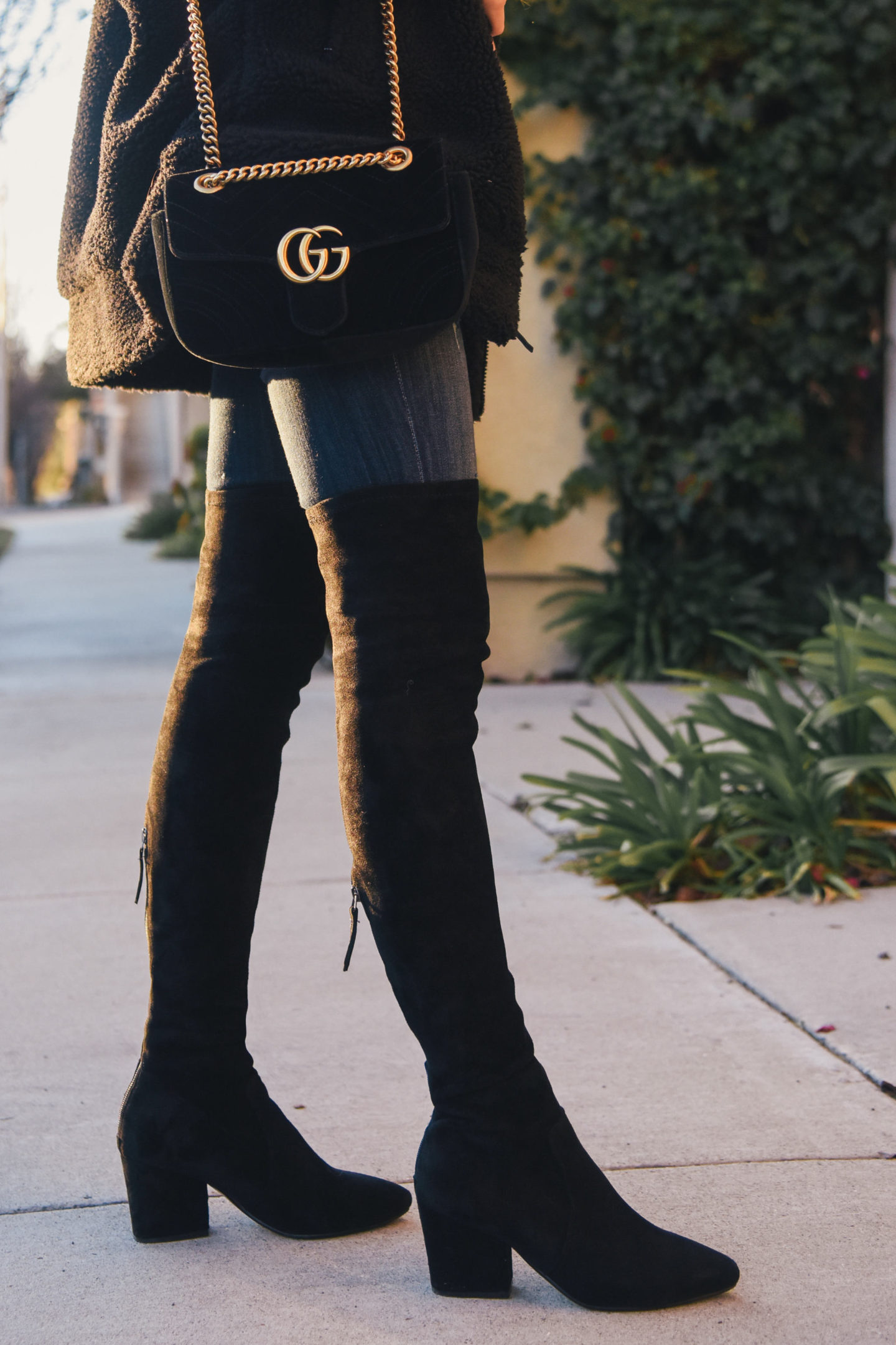 brunette wearing teddy jacket over the knee boots winter out