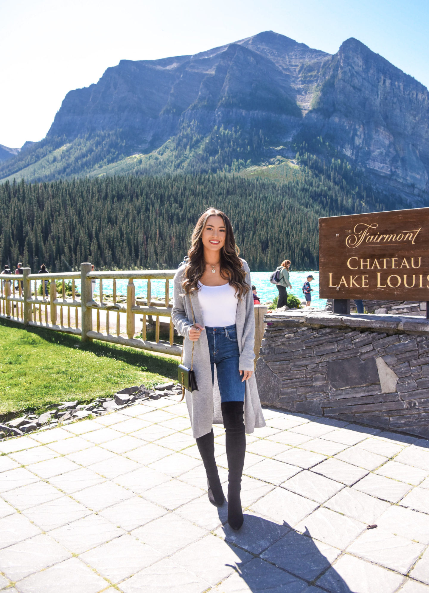 brunette wearing over the knee boots fall outfit lake louise canada